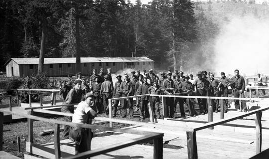 Civilian Conservation Corps members gather near buildings under construction. (Washington State Archives photo)