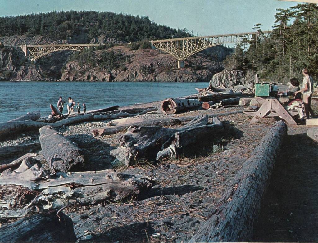 Deception Pass State Park visitors enjoy a view of the bridge from north beach in 1962.