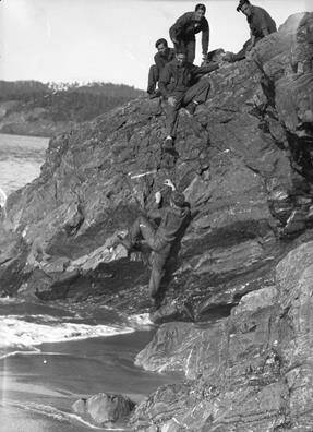 Civilian Conservation Corps members climb a rock in Deception Pass State Park in November 1933.
