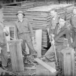 Above, a work crew chops wood in Deception Pass State Park. Below, Civilian Conservation Corps members gather near buildings under construction. (Washington State Archives photos)
