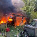 A storage shed and travel trailer were completely destroyed in a fire June 25. (Photo by South Whidbey Fire/EMS)
