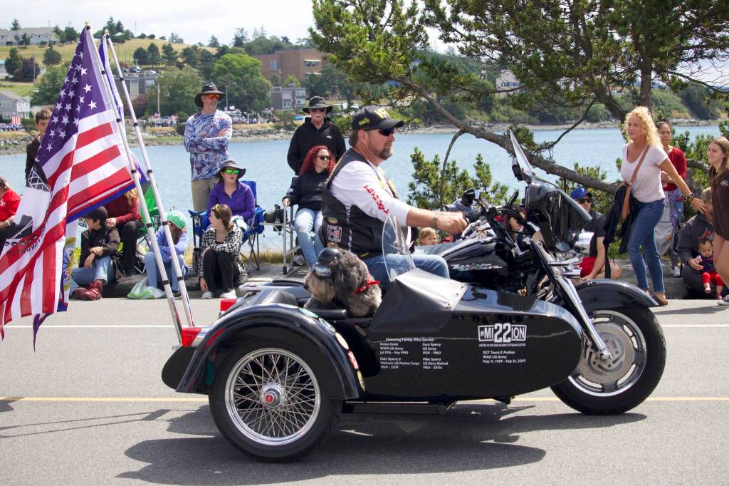 A member of the VFW rides through the Oak Harbor Fourth of July parade on a motorcycle.