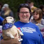 A woman from the Best Friends Veterinary Center carries her pouch in the parade.