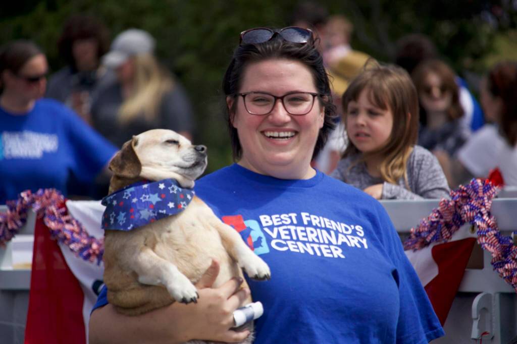 A woman from the Best Friends Veterinary Center carries her pouch in the parade.