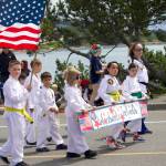 Students of Woodwards TaeKwanDo walk through the Oak Harbor Fourth of July parade.