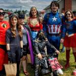 A family of superheroes keep an eye out for trouble during the Maxwelton parade.