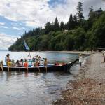 The Blue Heron Canoe Family is greeted on the shore at Sandy Point. (Photo by David Welton)