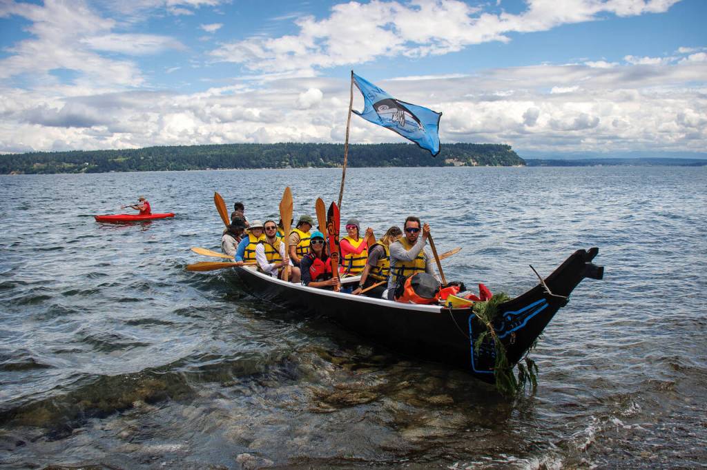 The Blue Heron Canoe arrives at Whidbey Island. (Photos by David Welton)