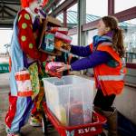 Deano the Clown helps a Girl Scout with her cookie delivery.