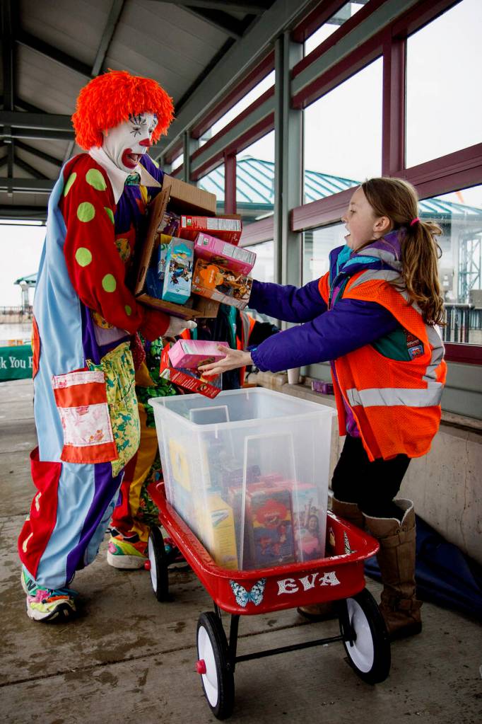 Deano the Clown helps a Girl Scout with her cookie delivery.