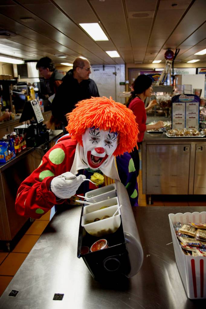 Deano the Clown tries a spoonful of pickles at the galley on a ferry running the Mukilteo-Clinton route.