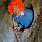 Dean Petrich appears from a secret tunnel at his clown house in Freeland. The home, which he built himself, is made entirely of recycled materials.