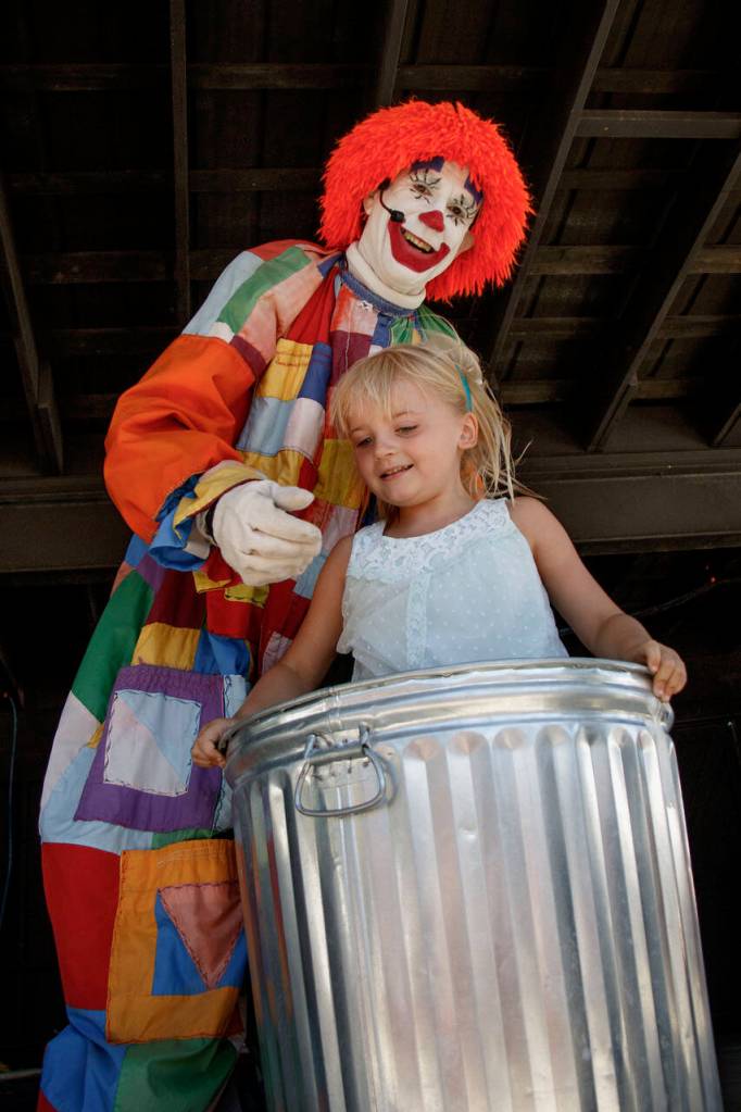 Deano the Clown places a child in an empty trashcan during a previous show at the Whidbey Island Fair. (Photo by David Welton)