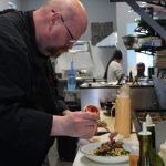 Gordon Stewart prepares a meal at Gordons Fusion July 8. (Photo by Karina Andrew/Whidbey News-Times)