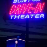 Minions: The Rise of Gru plays on the projector screen as the Blue Fox Drive-In Theater sign glows in the nighttime at the Oak Harbor outdoor movie theater. (Ryan Berry / The Herald)