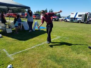 A participant wearing fatal vision goggles attempts to walk in a straight line at last year's National Night Out. (Photo provided by Oak Harbor Police Department)