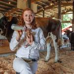 Photos by David Welton
Cadence Smith, 15, bottle-feeds a piglet that is just a few days old. Smith is showing dairy cows, steers and swine at the Whidbey Island Fair this year.