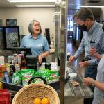 Maria Rios, a galley cashier, helps Frank and Fran Butler, of Washington, D.C., with food purchases aboard the Suquamish ferry between Mukilteo and Clinton. The galley is among several reopened after being closed over two years due to the pandemic. The galley of the Tokitae, the other boat on the Mukilteo-Clinton route, remains closed for now. (Ryan Berry / The Herald)