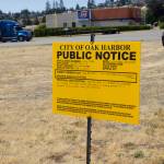 The city of Oak Harbor placed a notice on the corner of Tate Route 20 and Barrington Drive. (Photo by Rachel Rosen/Whidbey News-Times)