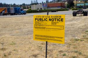 The city of Oak Harbor placed a notice on the corner of Tate Route 20 and Barrington Drive. (Photo by Rachel Rosen/Whidbey News-Times)