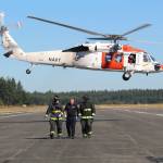 A Navy Search and Rescue helicopter takes off with two Navy personnel simulating critically wounded patients in a training Wednesday morning.
