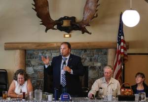 Photo by David Welton
Republican Tim Hazelo, a candidate for Island County commissioner, addresses attendees at a recent Old Goats  Fully Informed Voters luncheon. Left, Democrat and incumbent Janet St. Clair. Right, Rufus and Reece Rose, organizers of the discussion group.