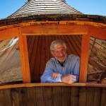 Photo by David Welton
Dan Neumeyer peers out the window of his Hummingbird Yurt.
