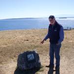 Photo by Rachel Rosen/Whidbey News-Times
Wayne Clark, a volunteer docent at Fort Casey State Park, stands next to the the new boulder and plaque that marks the spot of the original lighthouse at Admiralty Head.