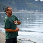 Photo by David Welton
Langley resident Gary Reeves reels in a fish at Robinson Beach in Freeland, near where the closed Mutiny Bay boat ramp is located.
