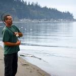 Photo by David Welton
Langley resident Gary Reeves reels in a fish at Robinson Beach in Freeland, near where the closed Mutiny Bay boat ramp is located.
