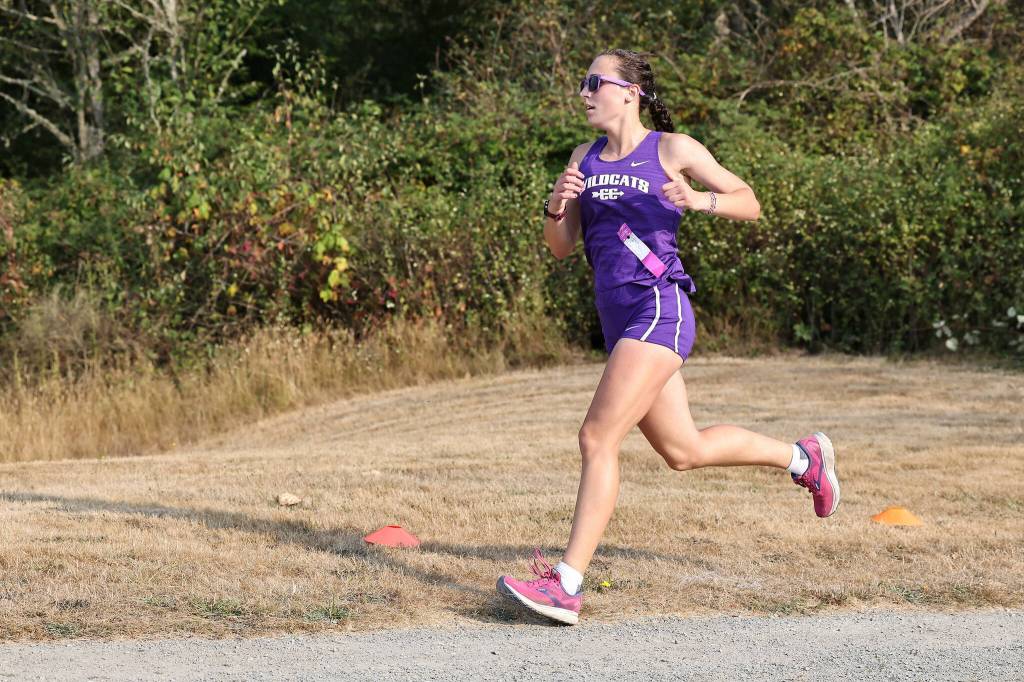 Photo by John Fisken
The Oak Harbor cross country girls team placed second at the first league meet of the year on Sept. 14 at the Skagit Regional Airport Trails in Burlington, scoring 42 against home Burlingtons 26. Oak Harbors Adrienne Root (pictured) won the girls 5,000 meters race easily, finishing in 19:07, over two minutes ahead of the second place runner. Oak Harbor Junior Claire Paul was fourth overall with a time of 22:25.
The Oak Harbor cross country boys team defeated host Burlington-Edison 26-43. Oak Harbors Jacob Pearson finished second in the boys 5,000 meters with a time of 16:29, followed by Taylen Bader in 3rd at 17:36.