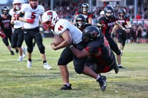 Photo by John Fisken
Coupeville athlete Josh Upchurch tackles a Bellingham player. The Coupeville High School varsity football team demolished Bellingham 48-6 before a sellout crowd Thursday. The victory lifts Coupeville to 5-1 this season.