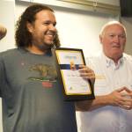 Photo by Rachel Rosen/Whidbey News-Times
Chief Ray Merrill presents a Lifesaver and Community Hero Award to Chris Stonecipher, who prevented his teammate from falling when she was having a medical emergeny during a basketball game.