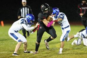 Photo be John Fisken
Coupeville High School senior running back Dominic Coffman rips through La Conner tacklers on his way to a big gain in Fridays 78-0 win. Coffman leads the Wolves in rushing yards this season, and is third on the team with nine touchdowns.