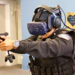 Photo by Rachel Rosen/Whidbey News-Times
Officer Shantel Ricci experiences a training scenario in the virtual reality world. She wears a headset connected to a backpack and carries a fake firearm.
