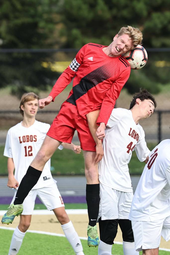 Senior Aidan Wilson heads the ball in a game against Lopez Oct. 29. (Photo by John Fisken)
