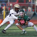 Taiis Hardin tackles an opponent during the playoff game at Edmonds Oct. 28. (Photo by John Fisken)