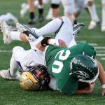 Aiden Finley tackles an opponent during the playoff game at Edmonds Oct. 28. (Photo by John Fisken)