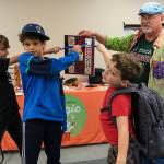 From left to right, Cam Peloetier, 10, Miles Guggenheim, 9, and Dylan Gluckman-Oskin, 7, point to a card on the board that was chosen.