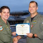 Capt. Eric Hanks, left, presents Chief Ryan Mooney with the Navy Marine Corps Medal Oct. 31.