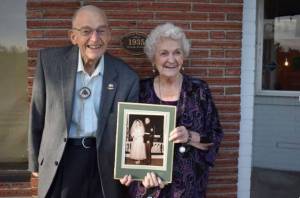 Eugene “Dud” Gilbert and Dorothy Gilbert pose for a photo just steps away from where they first met in downtown Oak Harbor 70 years ago. Photo by Emily Gilbert