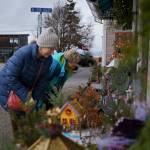 Photo by David Welton
Passersby in Langley pause to admire the Christmas village set up in front of Fair Trade Outfitters.