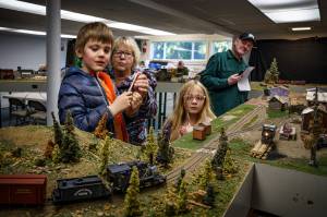 Photo by David Welton
Melene Thompson, with grandkids Lucas and Alexa, watch a model train go by.