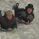 Photo by Karina Andrew/Whidbey News-Times
Oak Harbor High School sophomores Jayson Champignon, left, and Brayden Rupp race downhill on sleds.