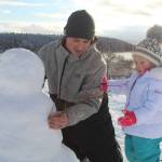 Corey Butler and his 3-year-old daughter, Tiffany, build a snowman together Tuesday afternoon in Oak Harbor. (Photo by Karina Andrew/Whidbey News-Times)
