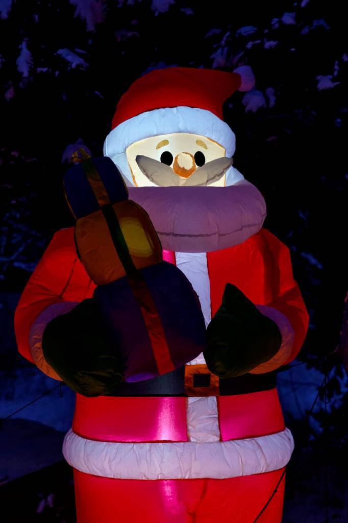 Multiple Santa Clauses decorate Jim Youngs yard. (Photo by David Welton)