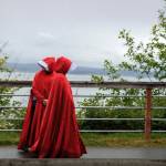 Women dress as Handmaids to protest the Supreme Courts decision to overturn Roe v. Wade over the summer. (Photo by David Welton)