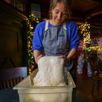 Courtney Storer flips focaccia dough. (Photo by David Welton)