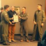 Photo by Karina Andrew/Whidbey News-Times
Air Force Brigadier General Tad Clark presents Captain Eric Hanks and NAS Whidbey Island with an art work depicting Clarks father and his pilot.