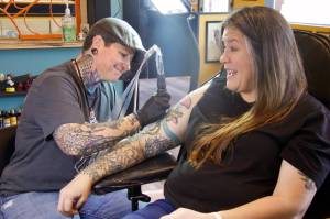 Photo by Rachel Rosen/Whidbey News-Times
Molly Vigallon tattoos Molly Waterbury in Nite Owls new location. Vigallon has been working at Nite Owl for eight years.